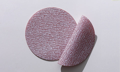 Flexible abrasive film discs and sheets ideal for contour and concave surface sanding on vehicles.