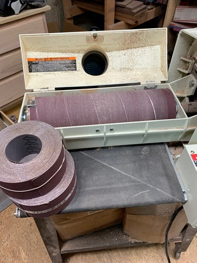 Variety of drum sander rolls displayed, suitable for different drum sizes and woodworking applications.