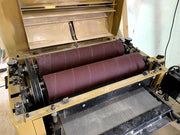 50-foot drum sander roll with durable hook and loop backing by Maverick Abrasives, ideal for woodworking and metalworking.