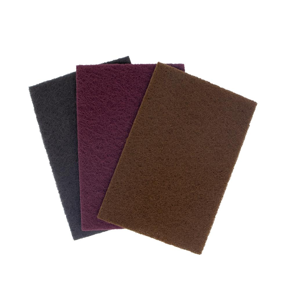 Alt text: Three 6 x 9 Premium Abrasive Hand Pads in coarse brown, very fine maroon, and ultra-fine grey, ideal for quality hand sanding.